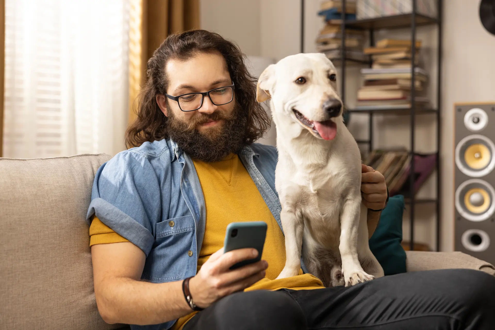 Happy man with your pet checking the fido app